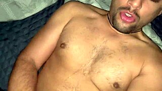 Two hung dudes banging hard on a bed in hot gay action.