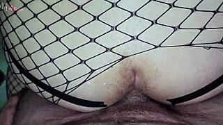 Stepdaughter wears full body fishnet and uses tape to open her ass for anal sex with stepfather in homemade video.