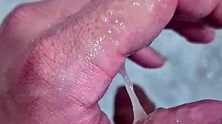 Pretty twink gets a sexy bathroom handjob and facial