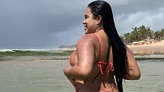 Long-haired brunette wife shows off her body in bikini