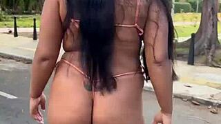 Long-haired brunette wife shows off her body in bikini