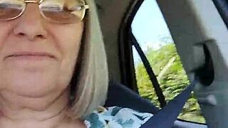 Shameless housewife exposing her breasts in a car