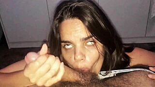A brunette gives a big cock a midnight BJ at home