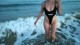 The blonde in a nano swimsuit shows her tits and makes blowjobs on the beach