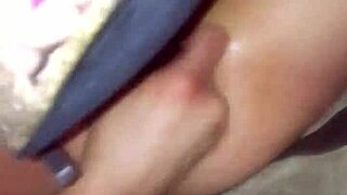 A mature woman plays with her ass using a toy, showcasing her allure