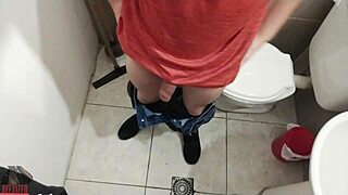 a skinny guy jerks off his big cock in the bathroom