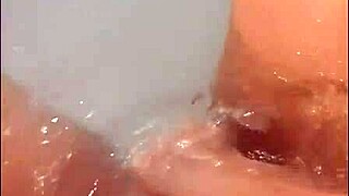 pretty woman masturbates in hot tub