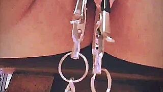 Big pink pussy lips dangled and stretched down with weights.