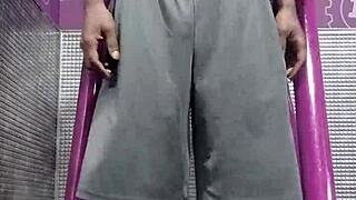 Black Brunette Uses Fitness Machine for Intense Gym Workout