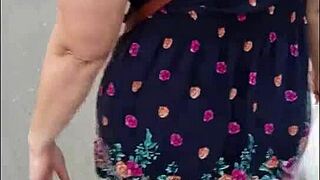 following that mature woman on the street with skirt and thong