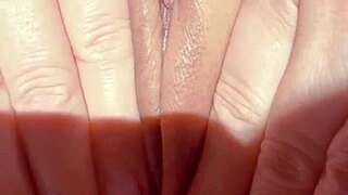 Early morning, this mature woman spreads her shaved pussy for masturbation