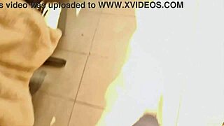 Confident 40-year-old woman tries on tight jeans in clothing store, showcasing her exaggerated curves.