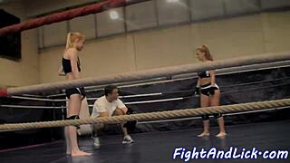 muscular women engage in intense wrestling match inside a boxing ring