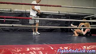 muscular women engage in intense wrestling match inside a boxing ring