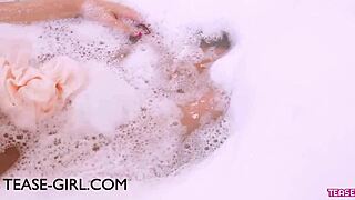 A stunning brunette model indulges in a relaxing bath