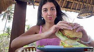 cute brunette flashes cum-covered face while munching burger in cafe